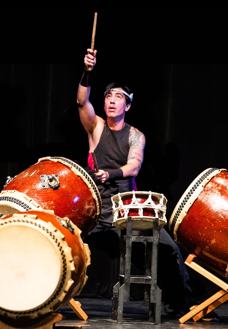 man playing taiko drum it