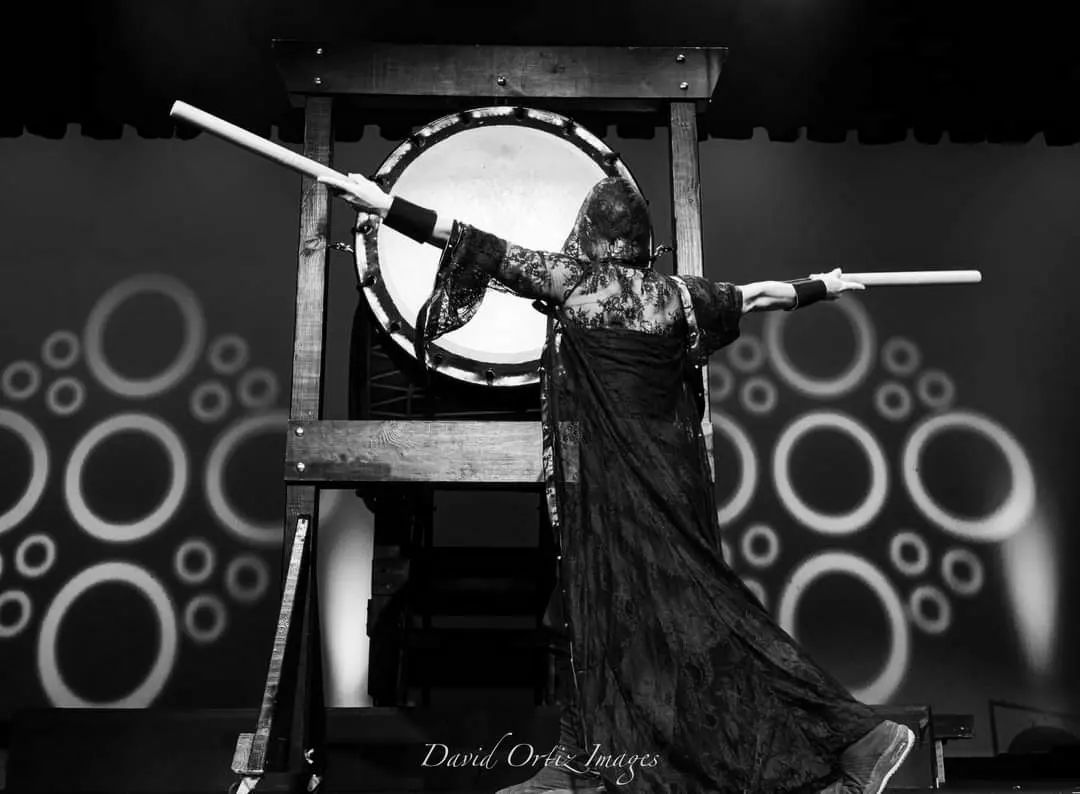 Woman playing large taiko drum